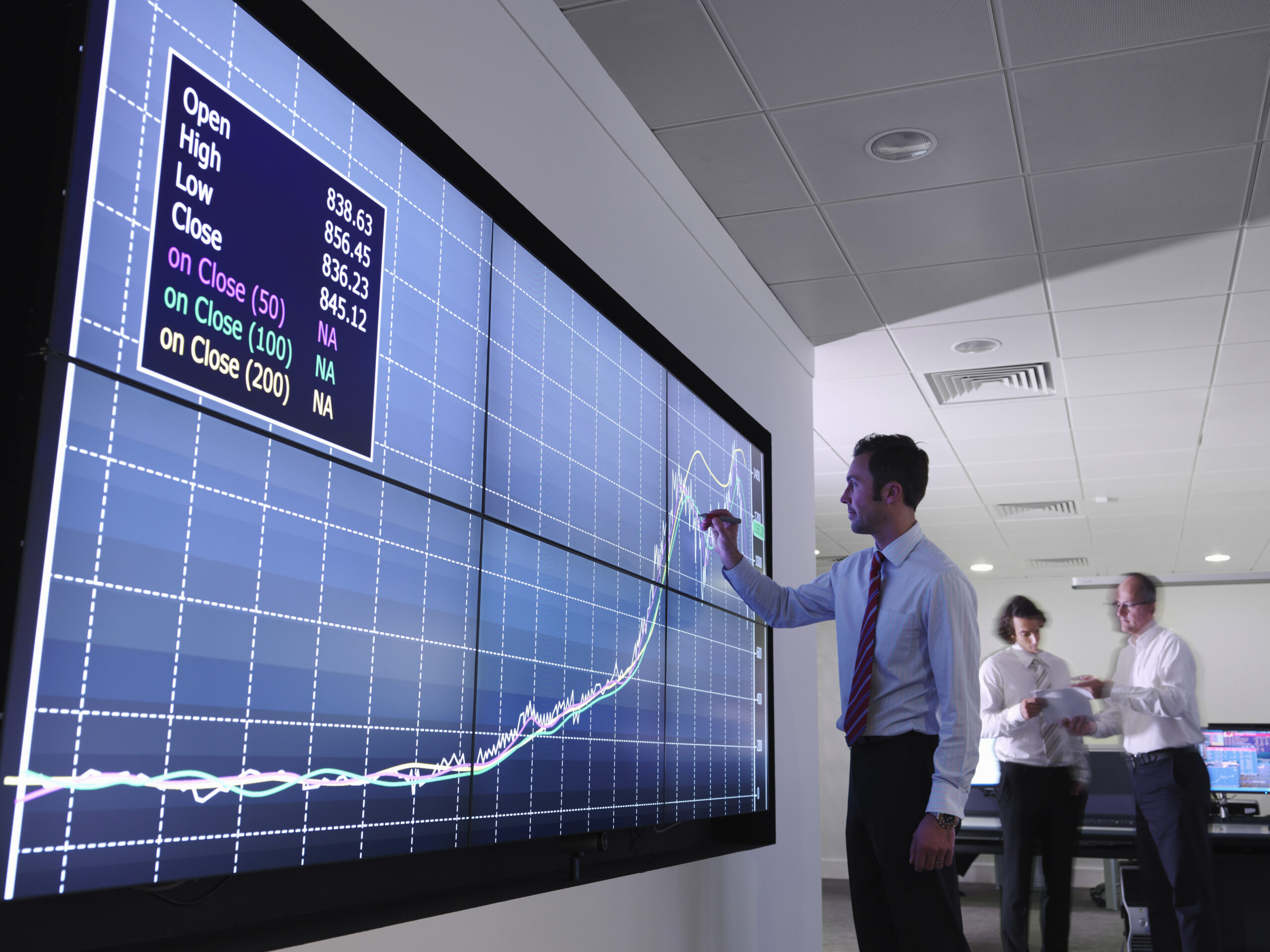 Businessman using graphs on screen